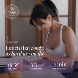 Woman eating an EatProtein chicken tikka ready meal at home — 19.5g protein, 377 calories a meal, 2 minutes in the microwave