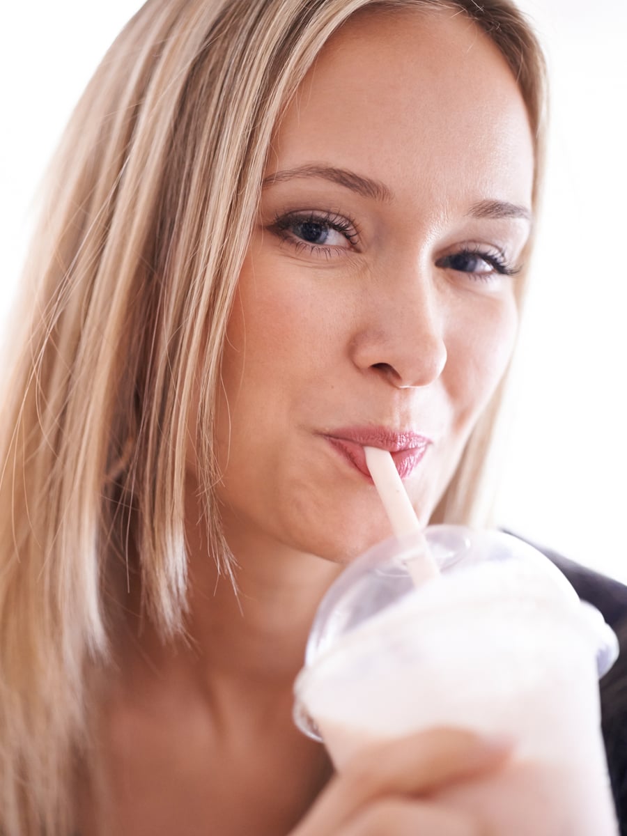 Shake That Weight meal replacements laid out with a glass of water