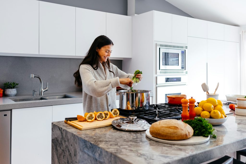 Woman cooking a meal with fresh vegetables in a bright home kitchen