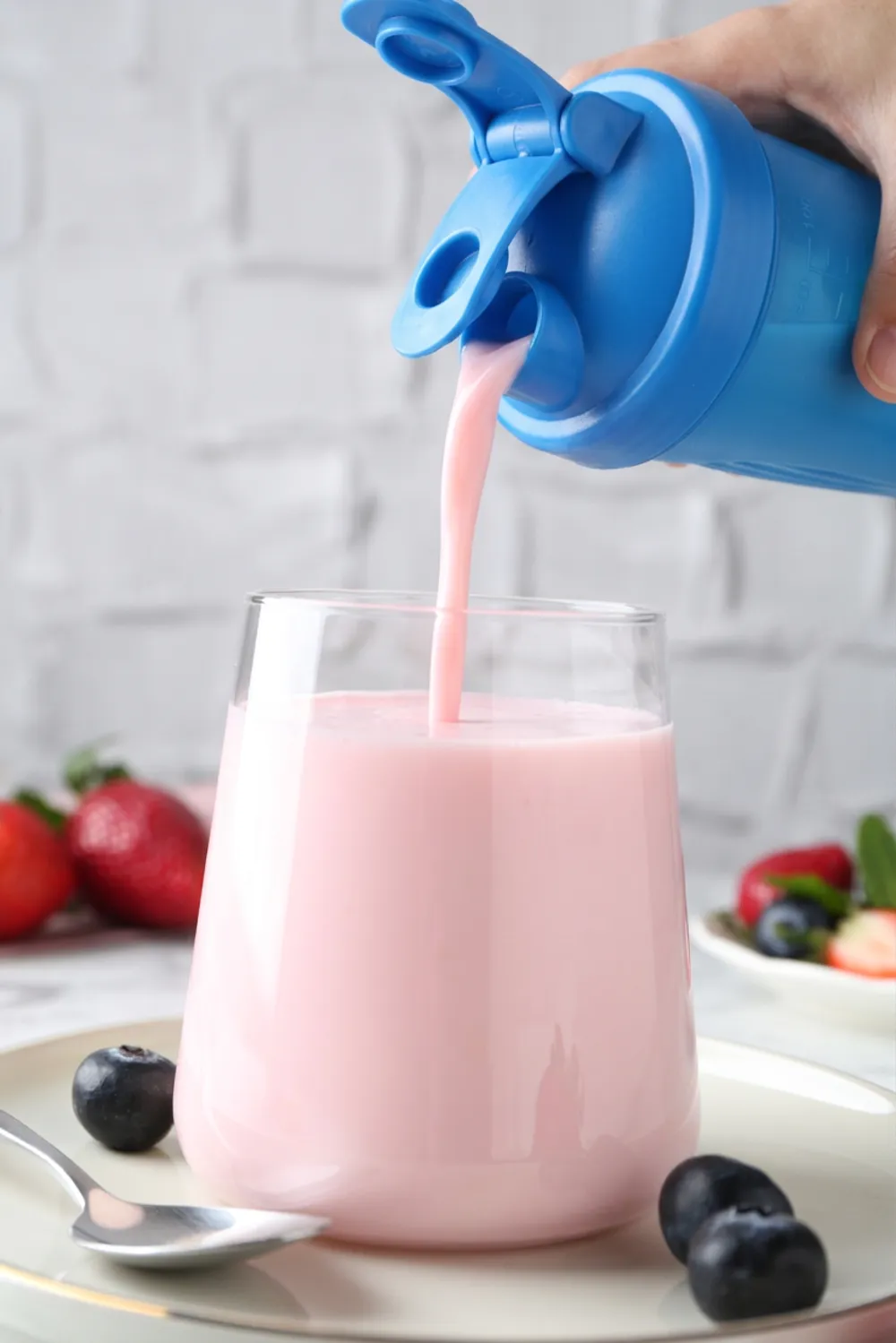 Meal shake being poured from a shaker into a glass